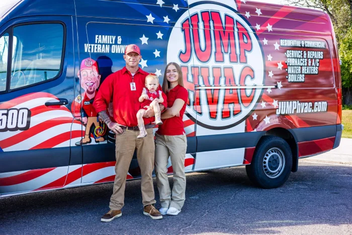 Family business owners standing with their toddler in front of a red, white, and blue Jump HVAC service van.
