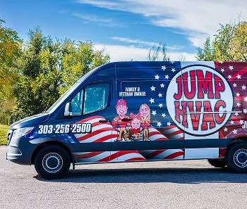 Profile view of a wrapped JUMP HVAC service vehicle parked outside under a bright blue sky with light clouds.